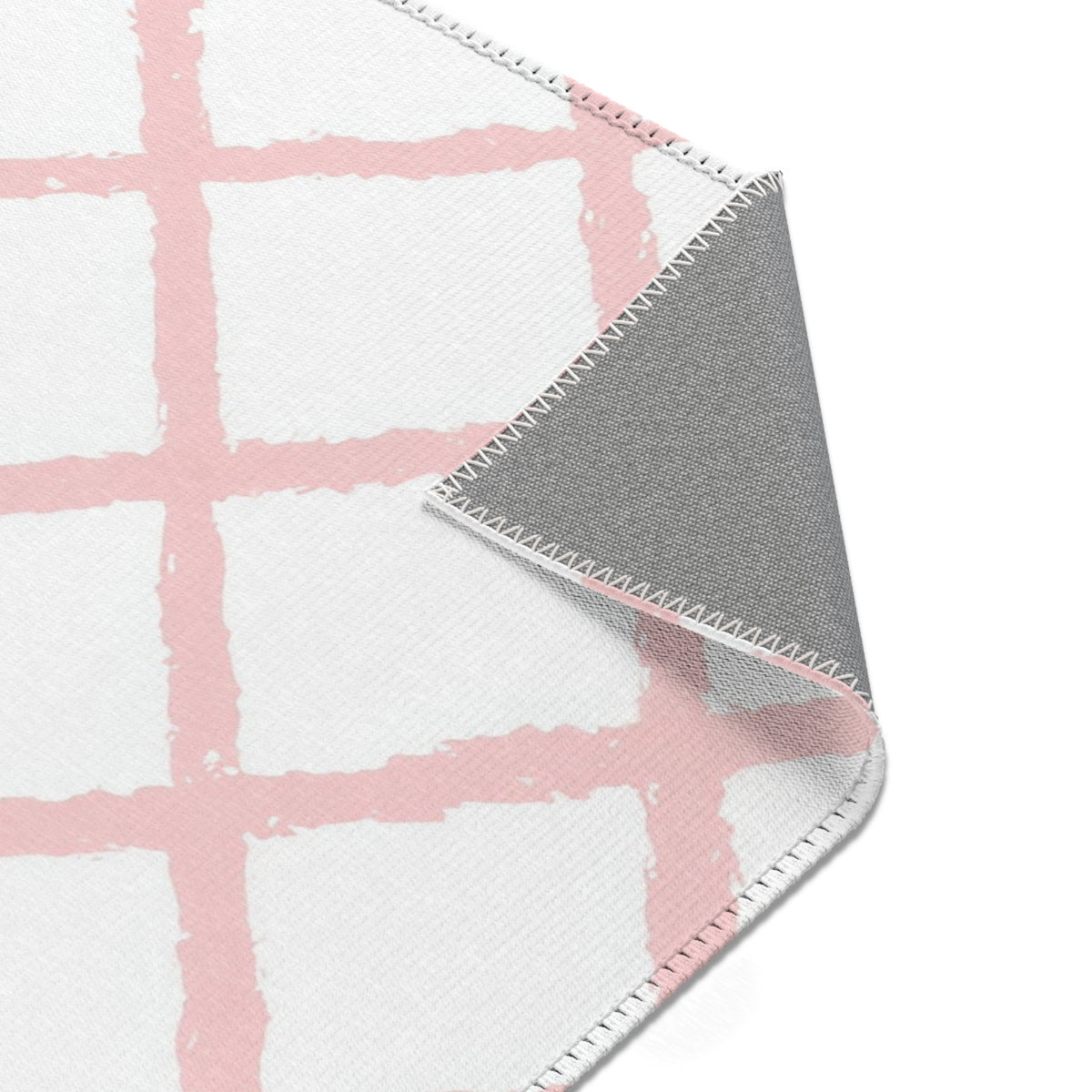 Pink trellis nursery rug edge and pile detail