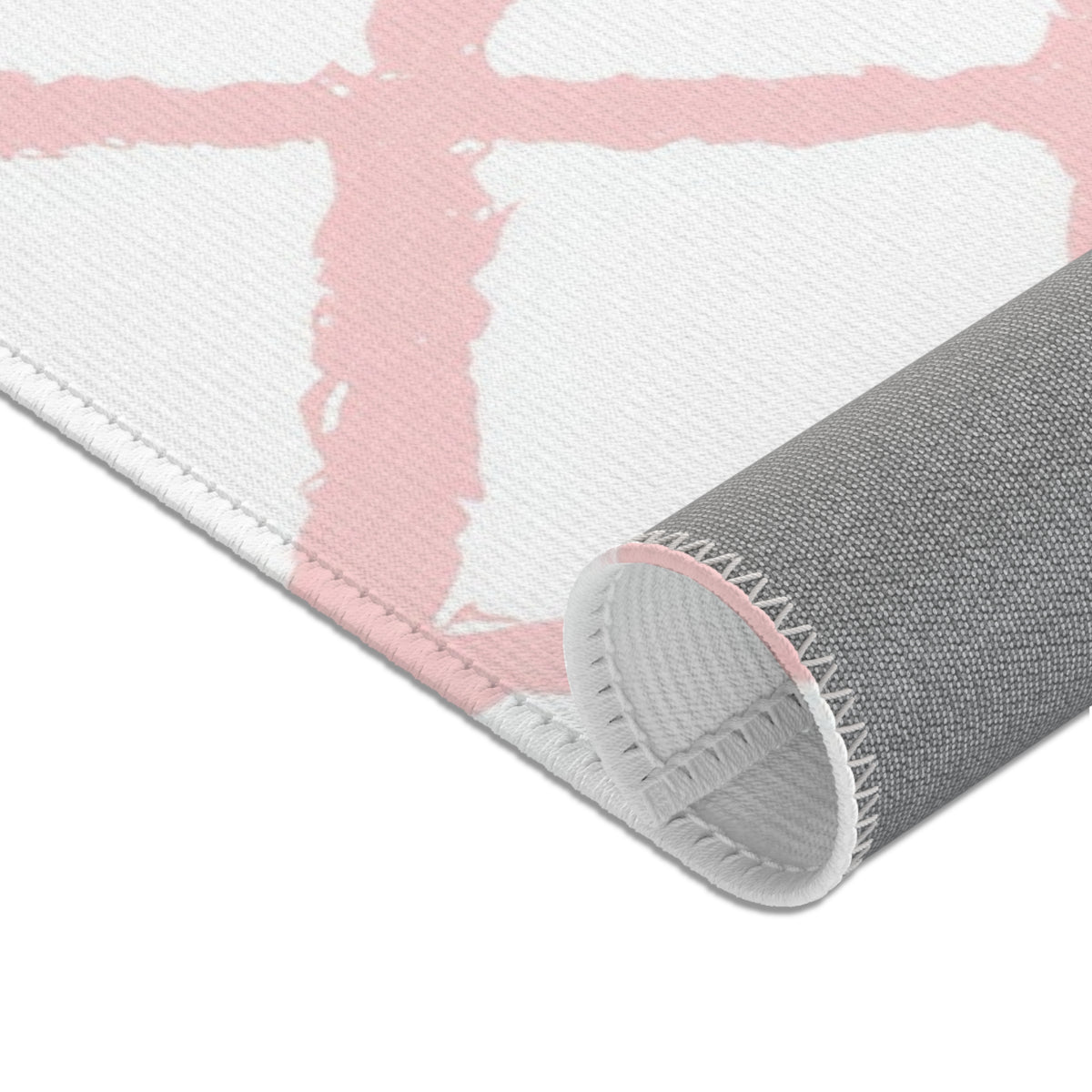 Pink trellis area rug in a small baby girl's room