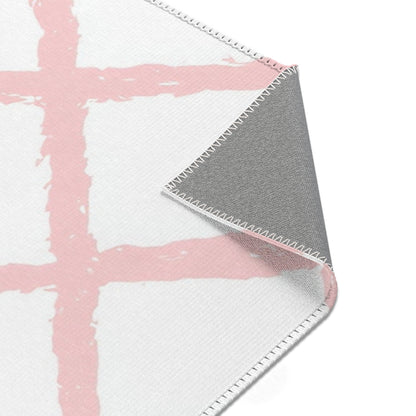Pink trellis rug seen from above in a nursery