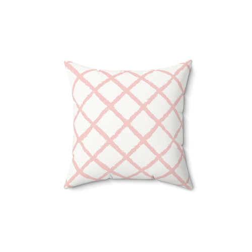 Pink trellis decorative nursery pillow on a glider chair