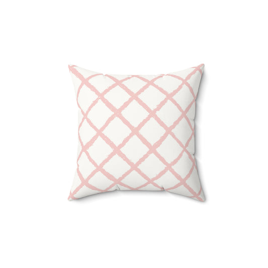 Pink trellis decorative nursery pillow on a glider chair