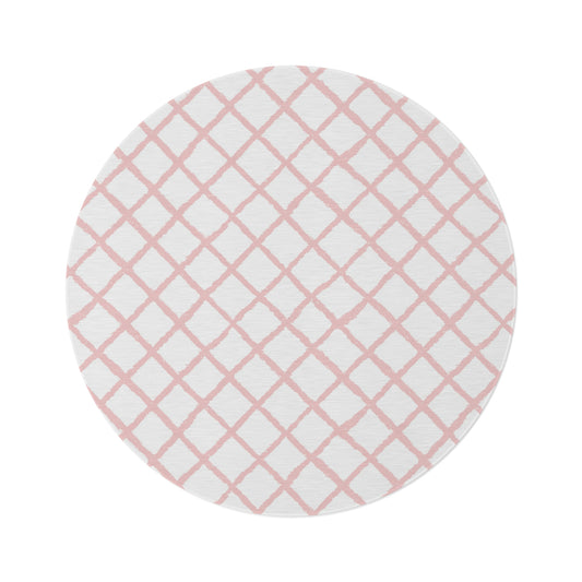 Pink trellis round nursery rug on a baby girl's bedroom floor