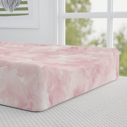 Close-up of the watercolor print on a pink changing pad cover