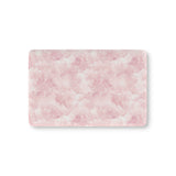 Pink watercolor clouds fitted crib sheet on a nursery crib mattress