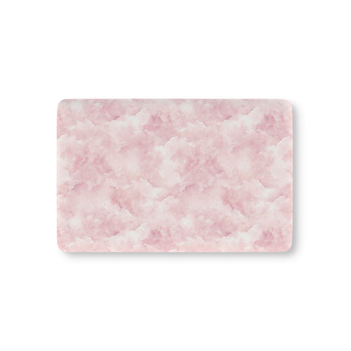 Pink watercolor clouds fitted crib sheet on a nursery crib mattress