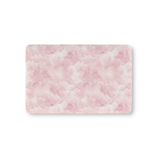 Pink watercolor clouds fitted crib sheet on a nursery crib mattress