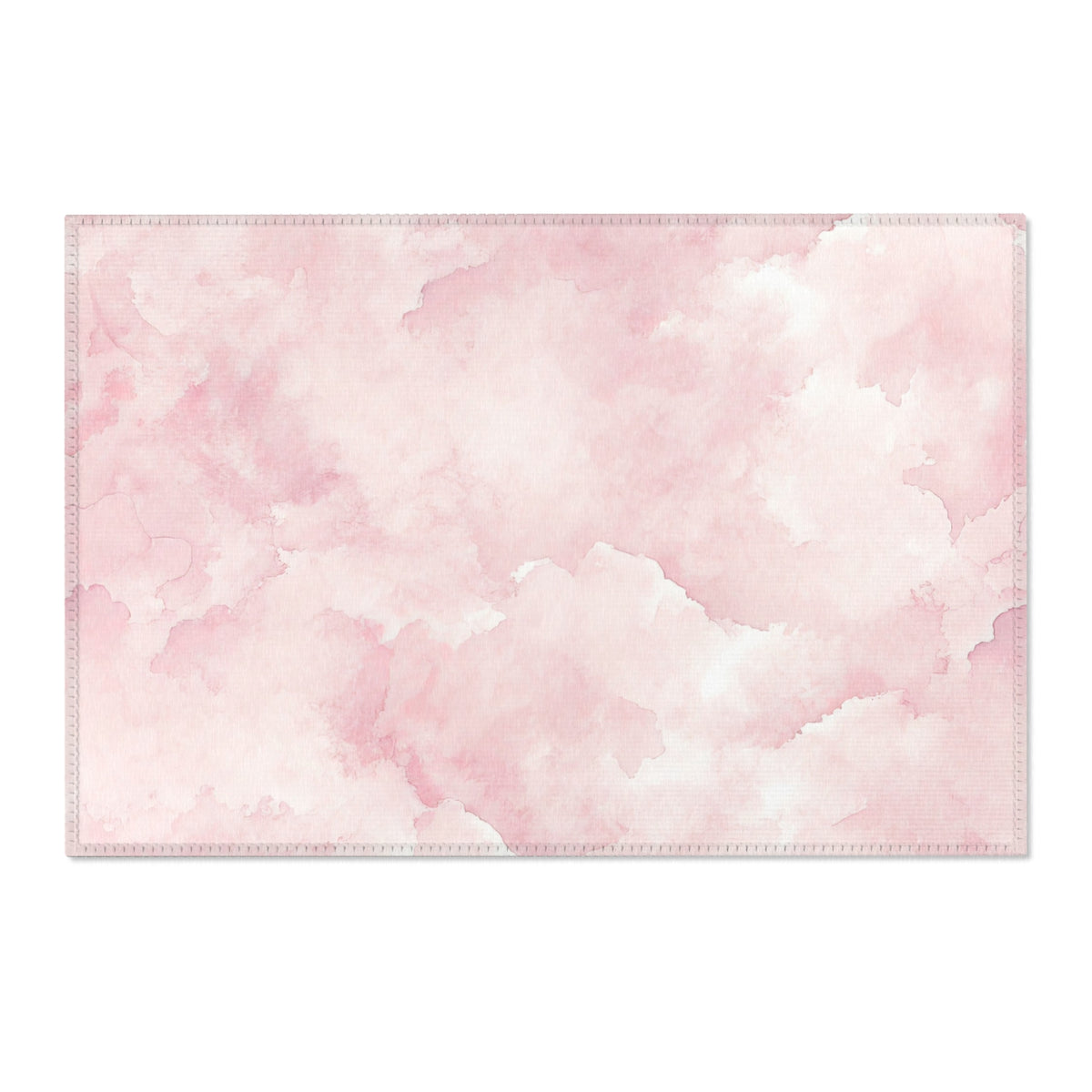 Washable pink watercolor clouds area rug under a nursery crib