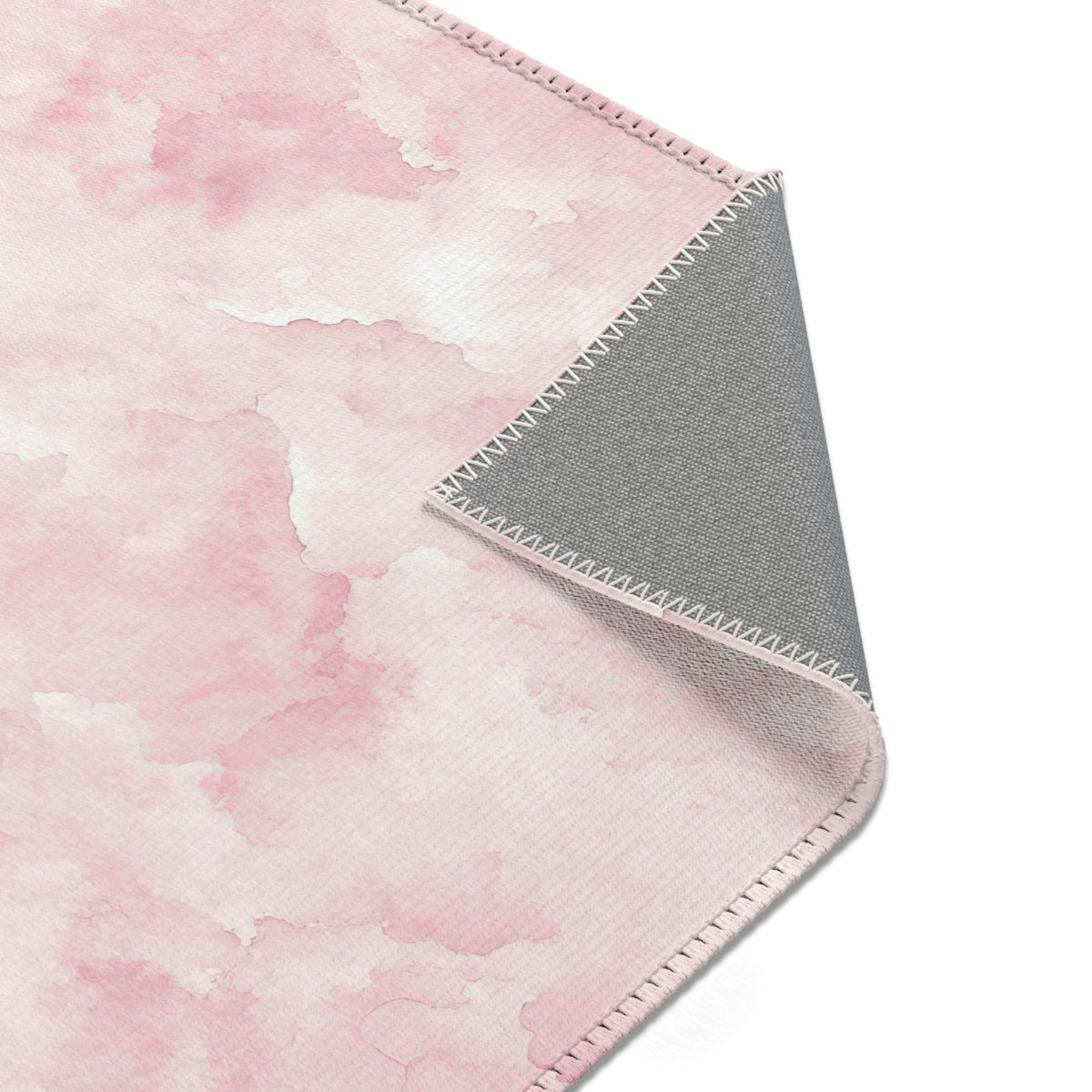 Pink watercolor clouds area rug styled with nursery furniture