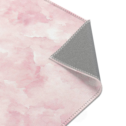 Pink watercolor clouds area rug styled with nursery furniture