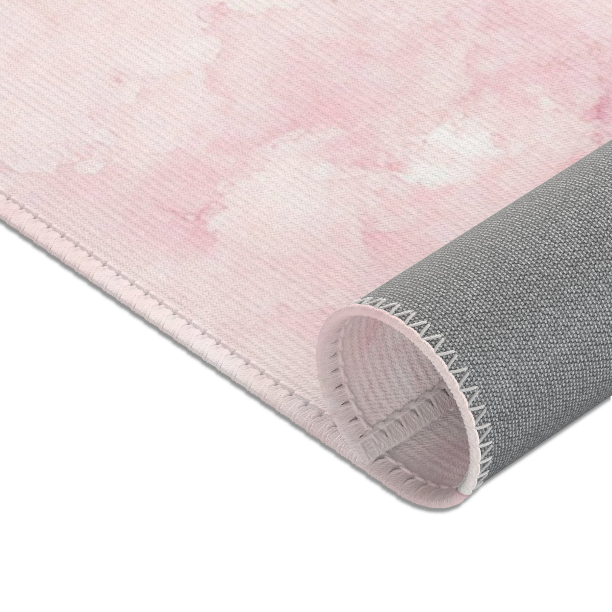 Soft pink cloud print area rug in a baby nursery corner