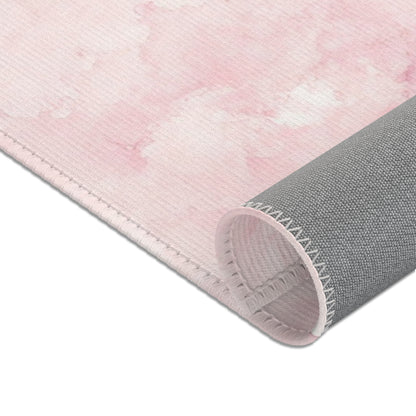 Soft pink cloud print area rug in a baby nursery corner