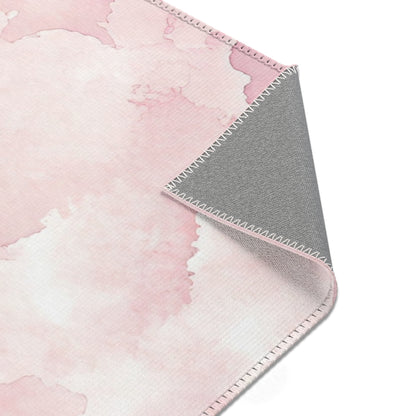 Soft pink cloud print rug on a light wood floor