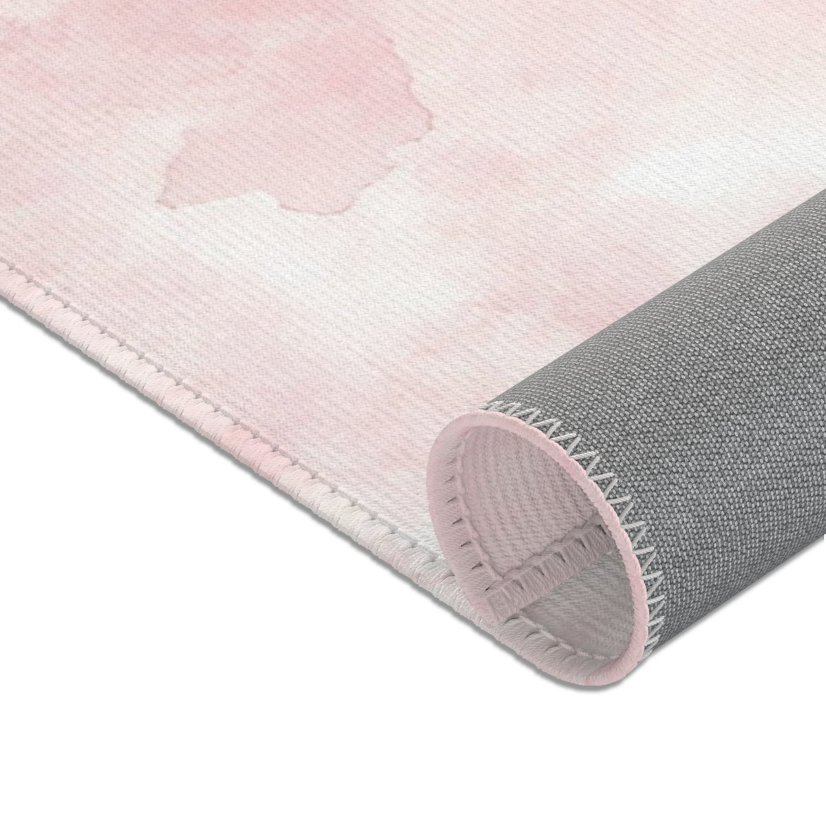 Pink watercolor clouds area rug in a small baby girl's room