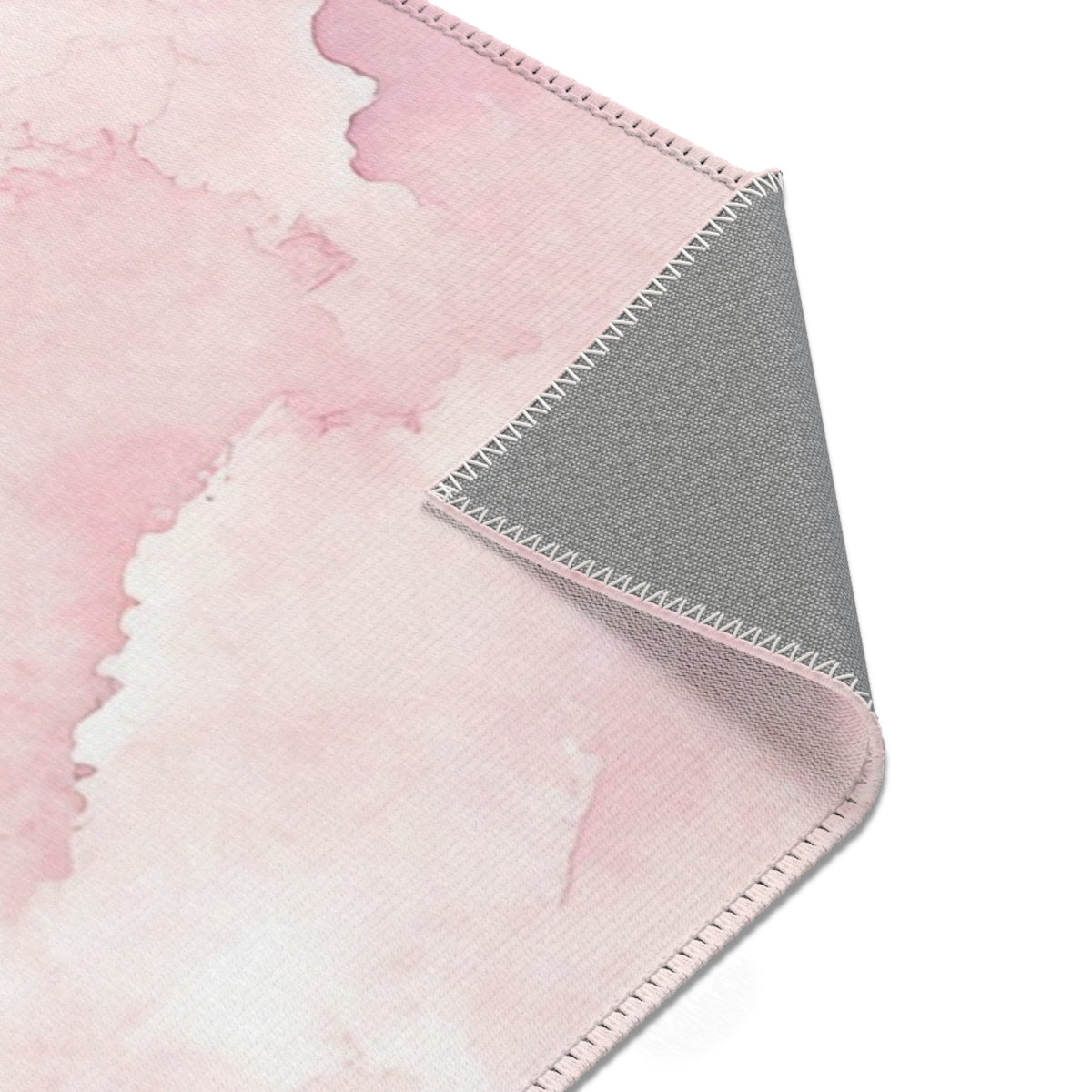 Pink watercolor clouds rug seen from above in a nursery