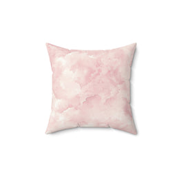 Pink watercolor clouds decorative nursery pillow on a glider chair