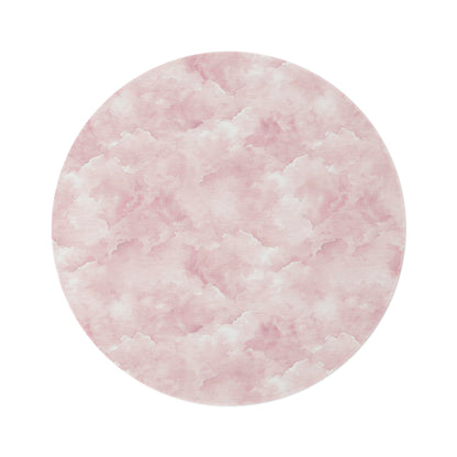 Pink watercolor clouds round nursery rug on a baby girl's bedroom floor