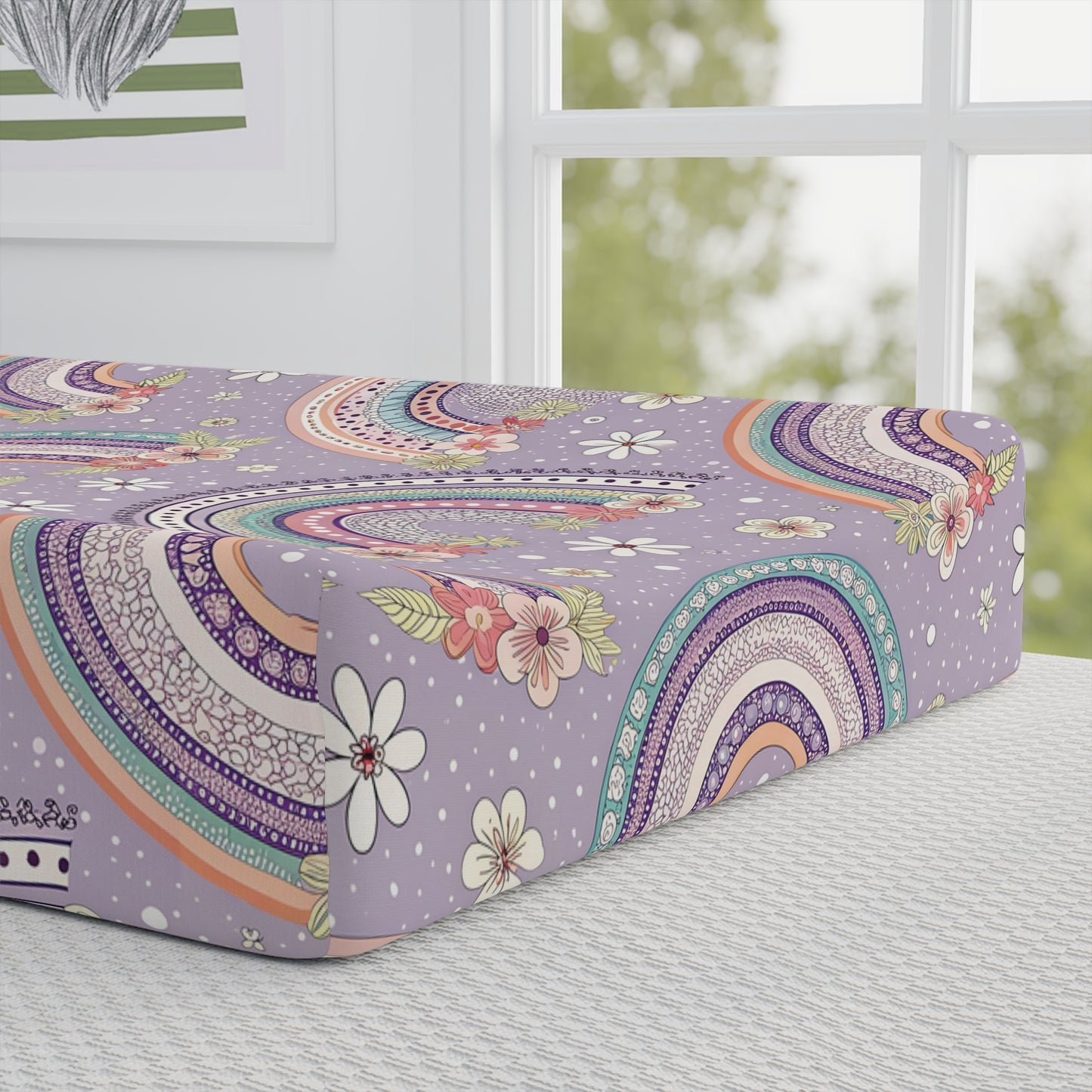 Close detail of the Posy Rainbows print on the changing pad cover