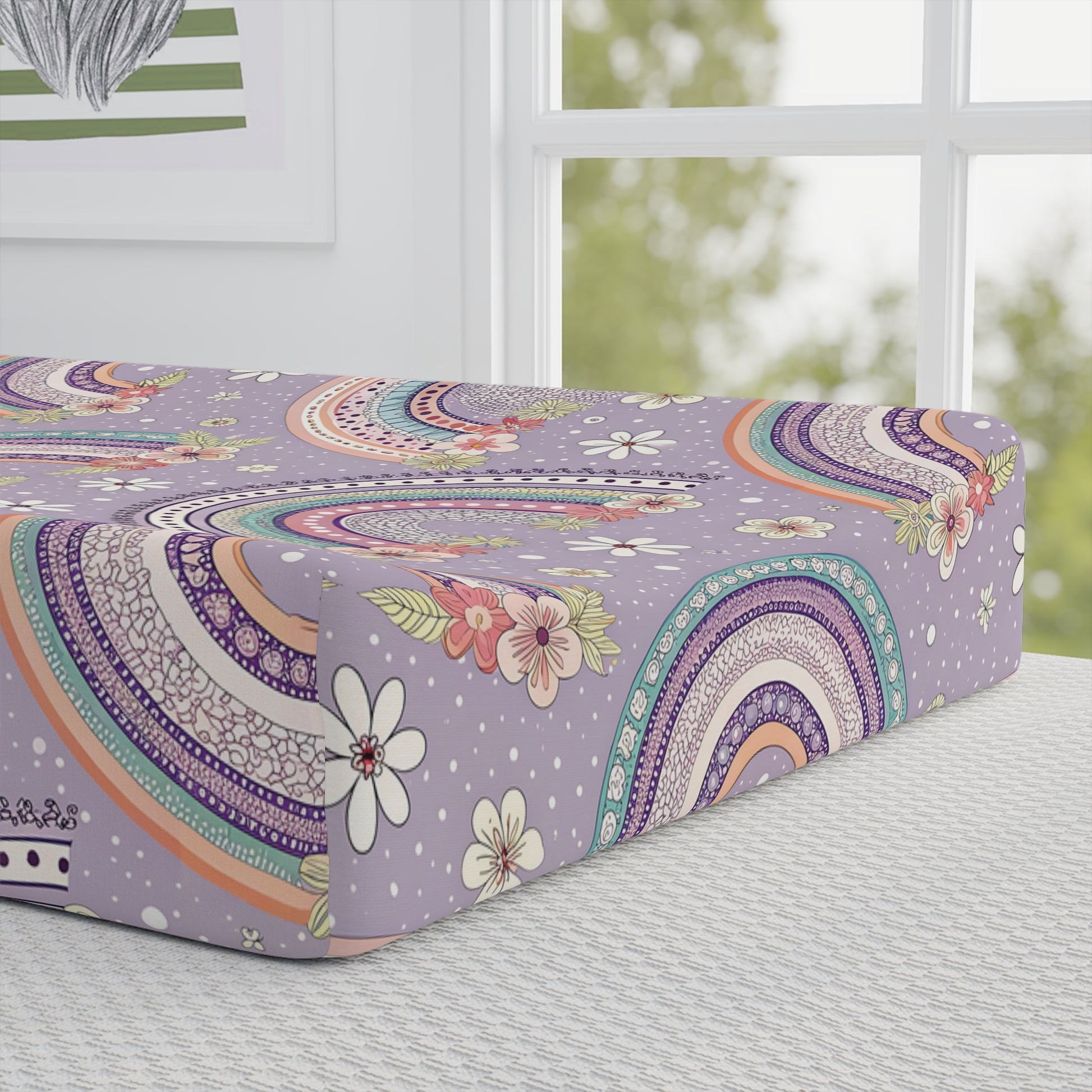 Close detail of the Posy Rainbows print on the changing pad cover