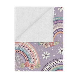 Posy Rainbows minky baby blanket draped over a crib