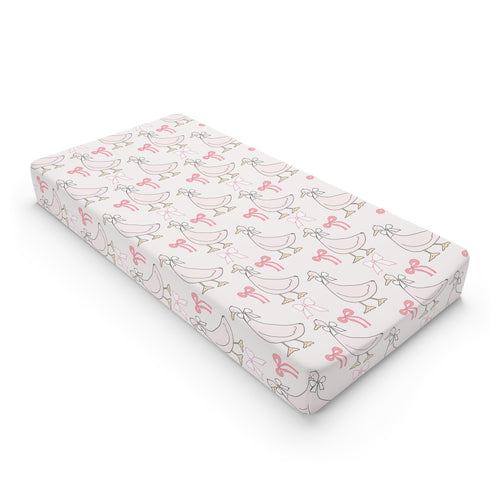 Ribbon Goose changing pad cover on a nursery changing table