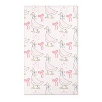 Pink goose and bow nursery area rug on blush