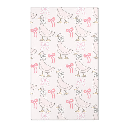 Pink goose and bow nursery area rug on blush