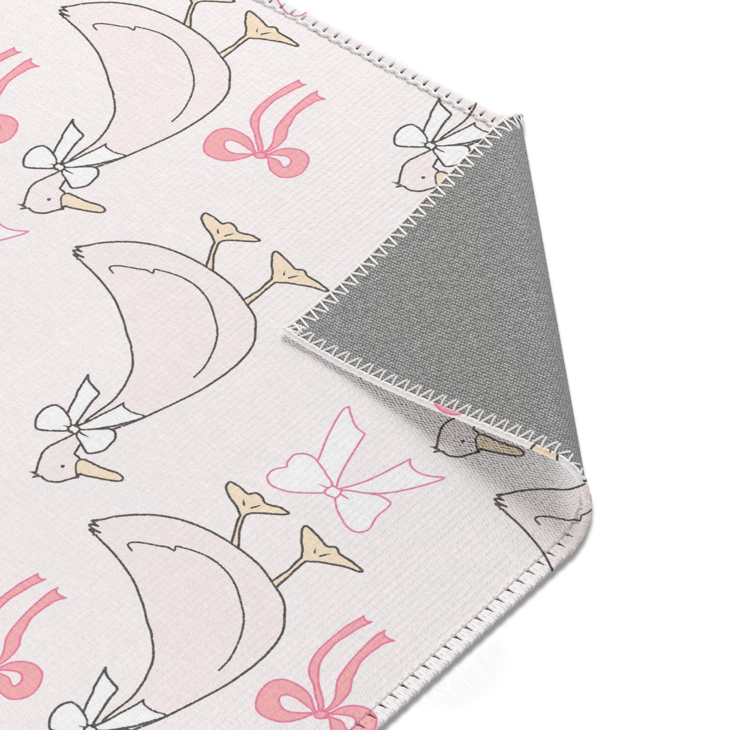 Ribbon Goose rug, geese in bows on a blush ground