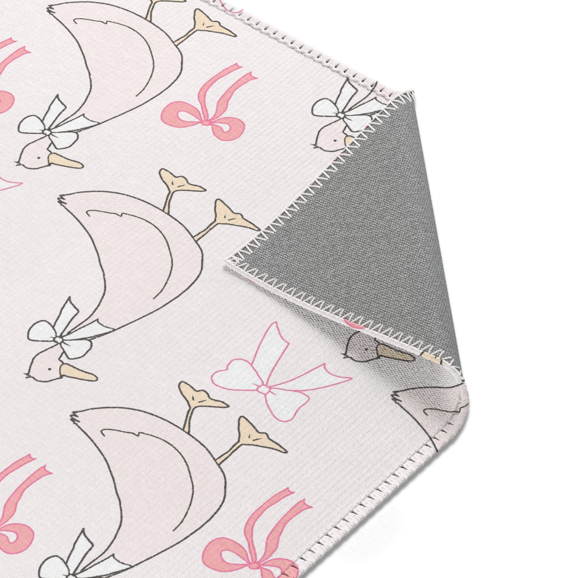 Ribbon Goose rug, geese in bows on a blush ground