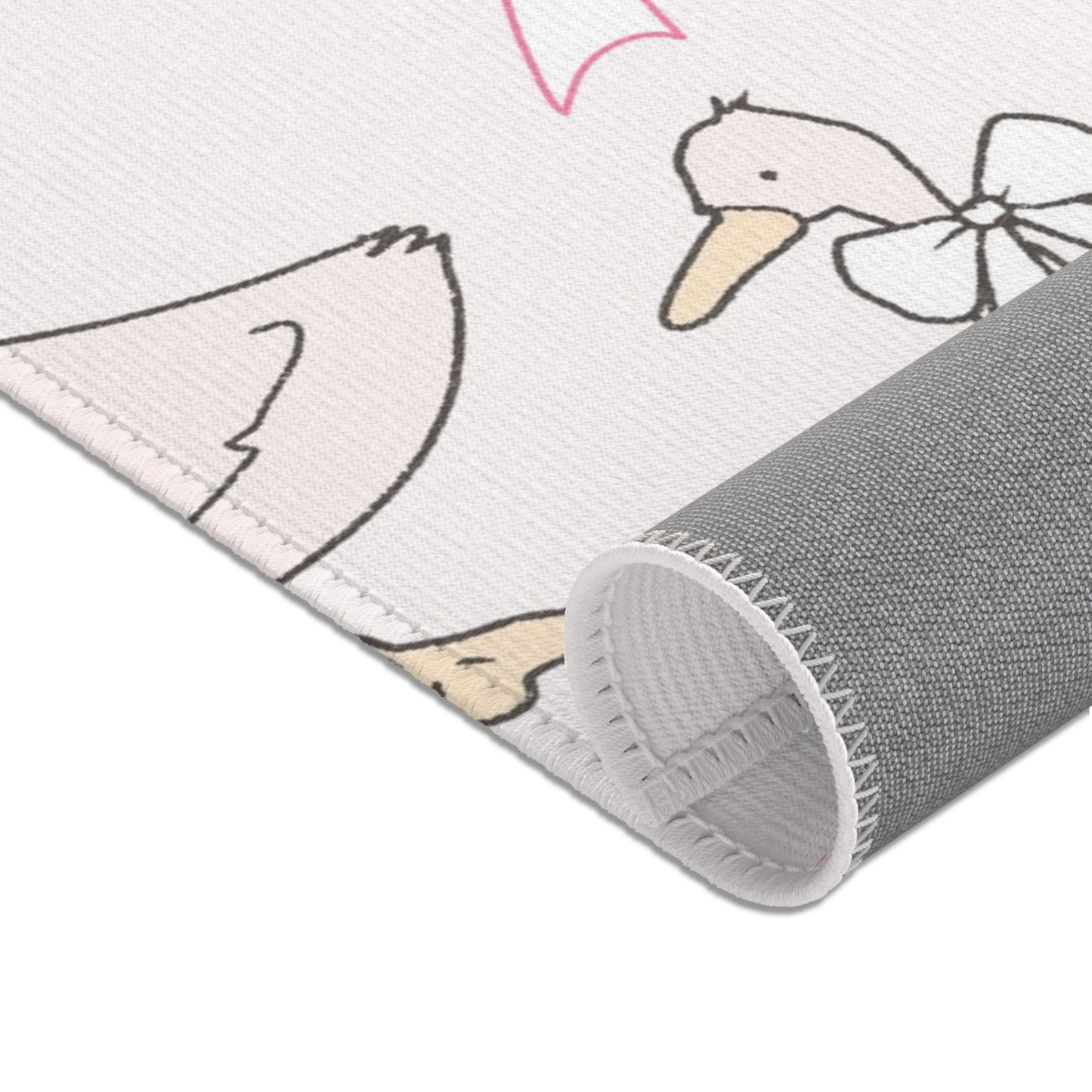 Pink goose area rug in a baby nursery corner