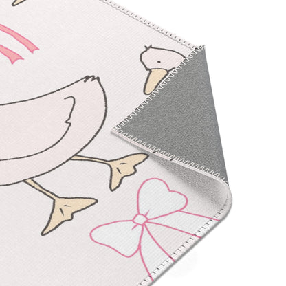Goose and bow print rug in a small baby room