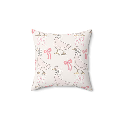 Ribbon Goose decorative nursery pillow on a glider chair