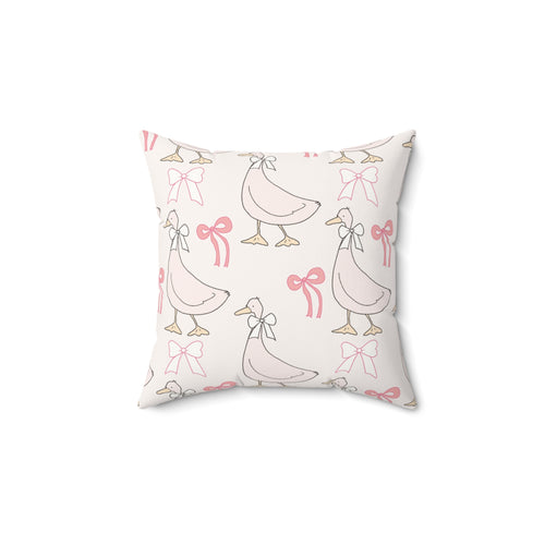 Ribbon Goose decorative nursery pillow on a glider chair
