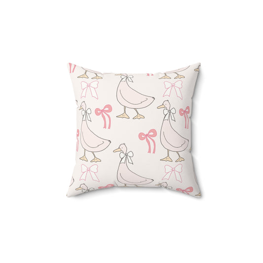 Ribbon Goose decorative nursery pillow on a glider chair