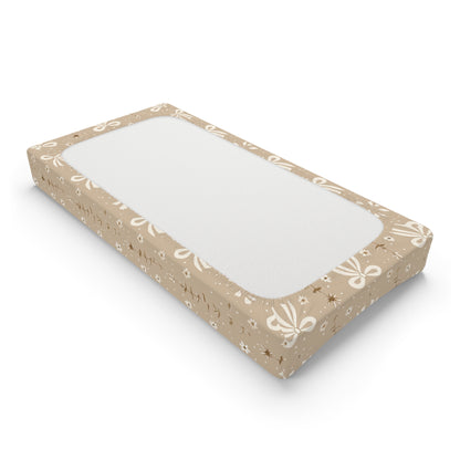 Changing pad cover with cream bows and small daisies on taupe