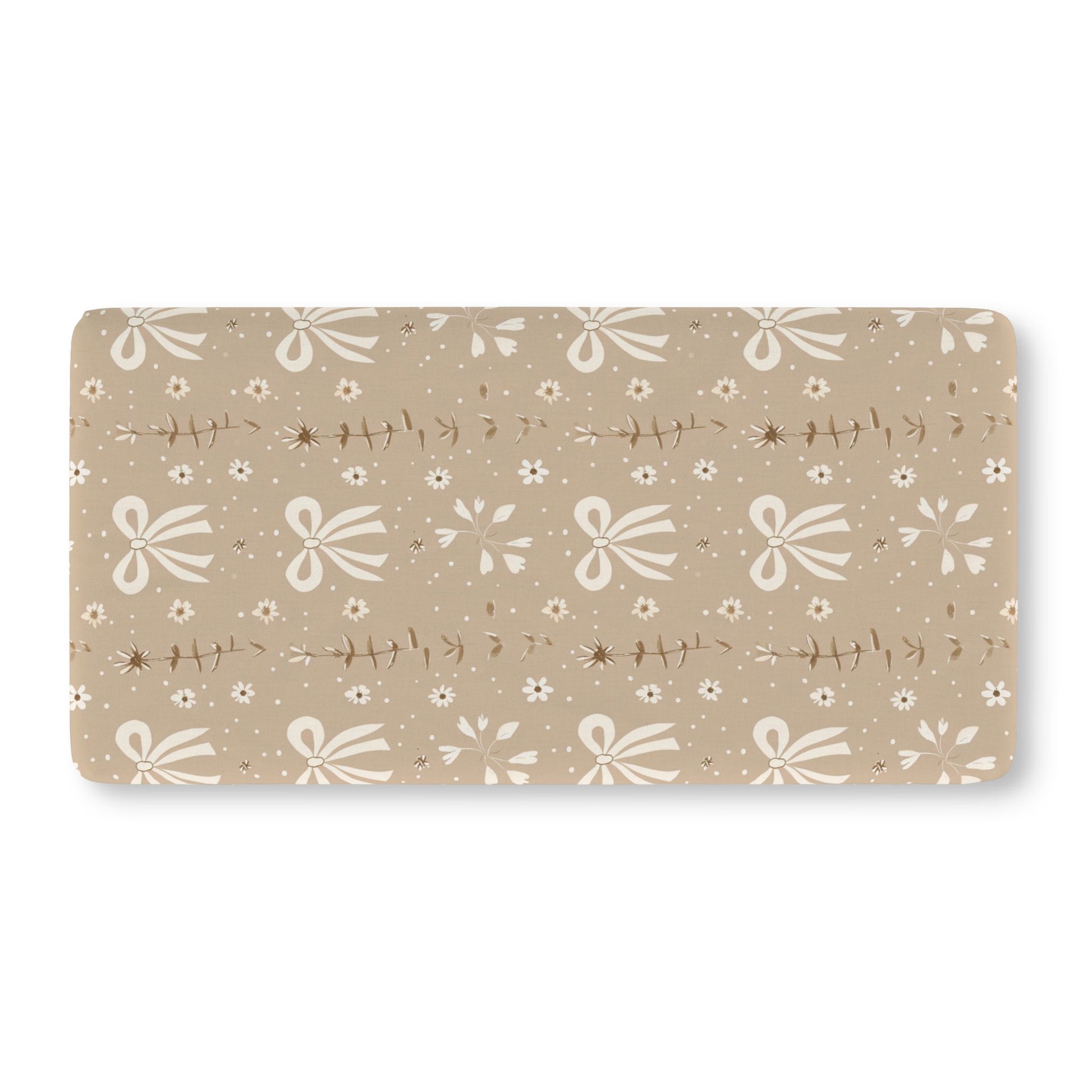 Fitted crib sheet with cream bows and daisies on taupe