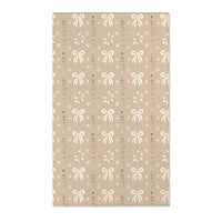 Bow and daisy nursery area rug in cream on soft taupe