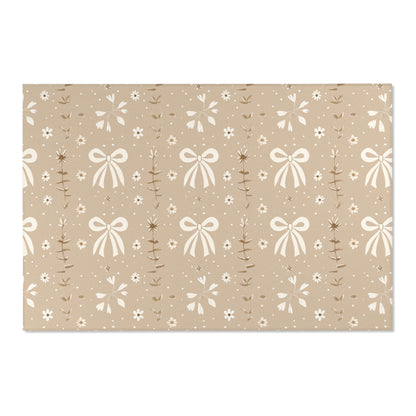 Low pile nursery rug with cream bows on a taupe ground