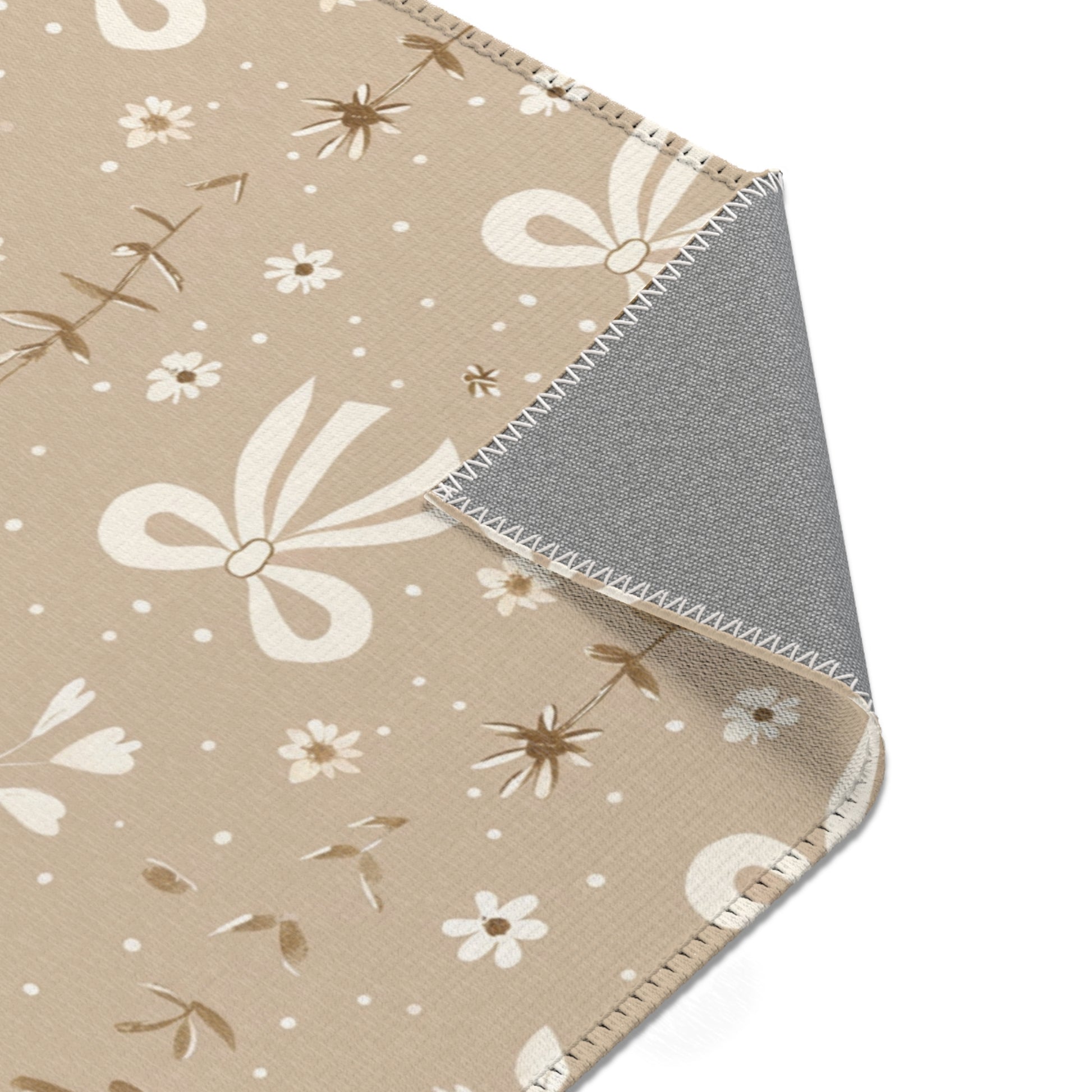 Bow print rug in cream and taupe for a nursery floor