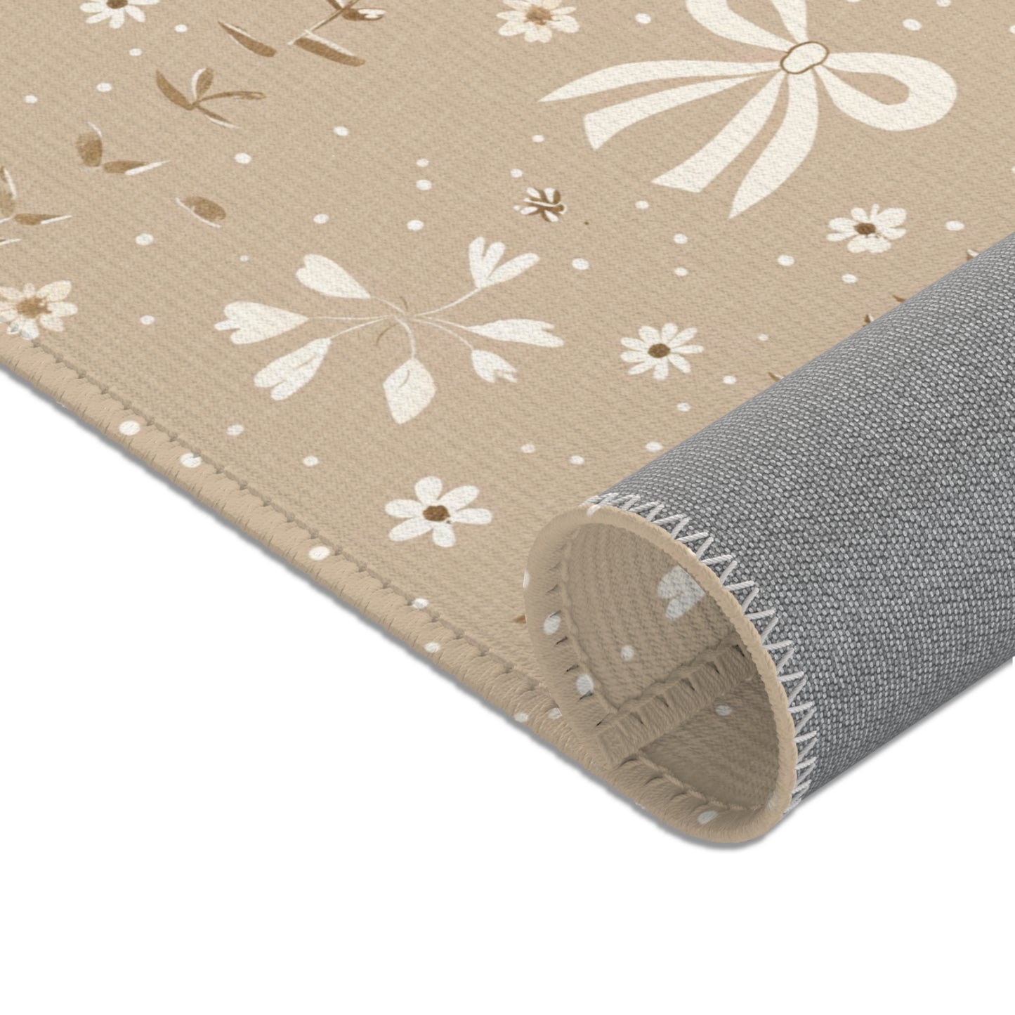 Rows of bows and daisies printed across the nursery area rug