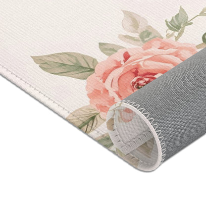 Nursery area rug in a blush, coral and sage palette