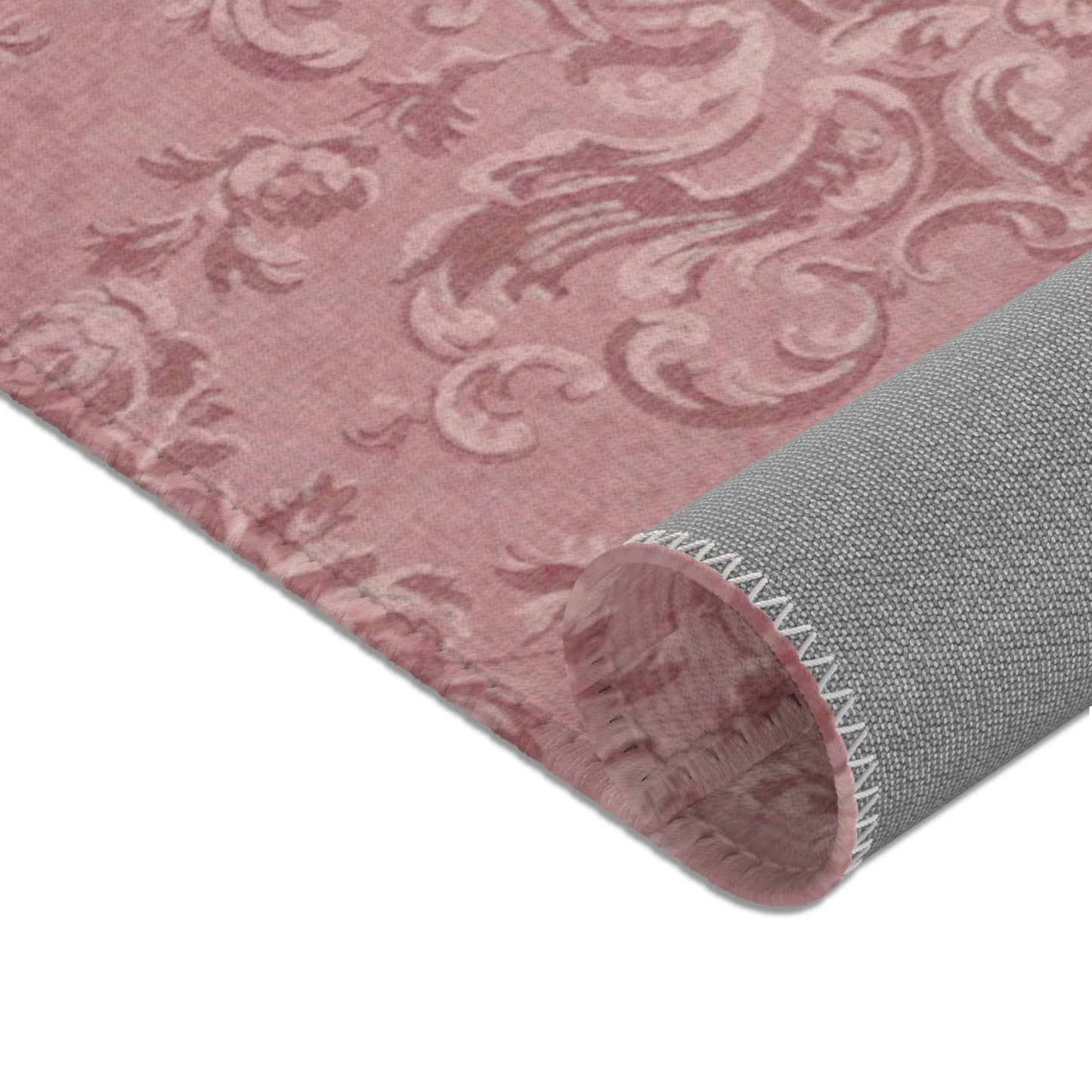 Scrolling foliage and lace swags across the nursery area rug