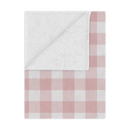 Rose Gingham minky baby blanket draped over a crib