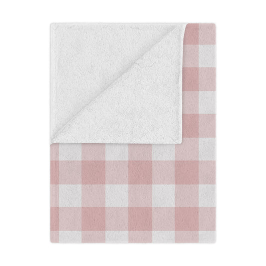 Rose Gingham minky baby blanket draped over a crib