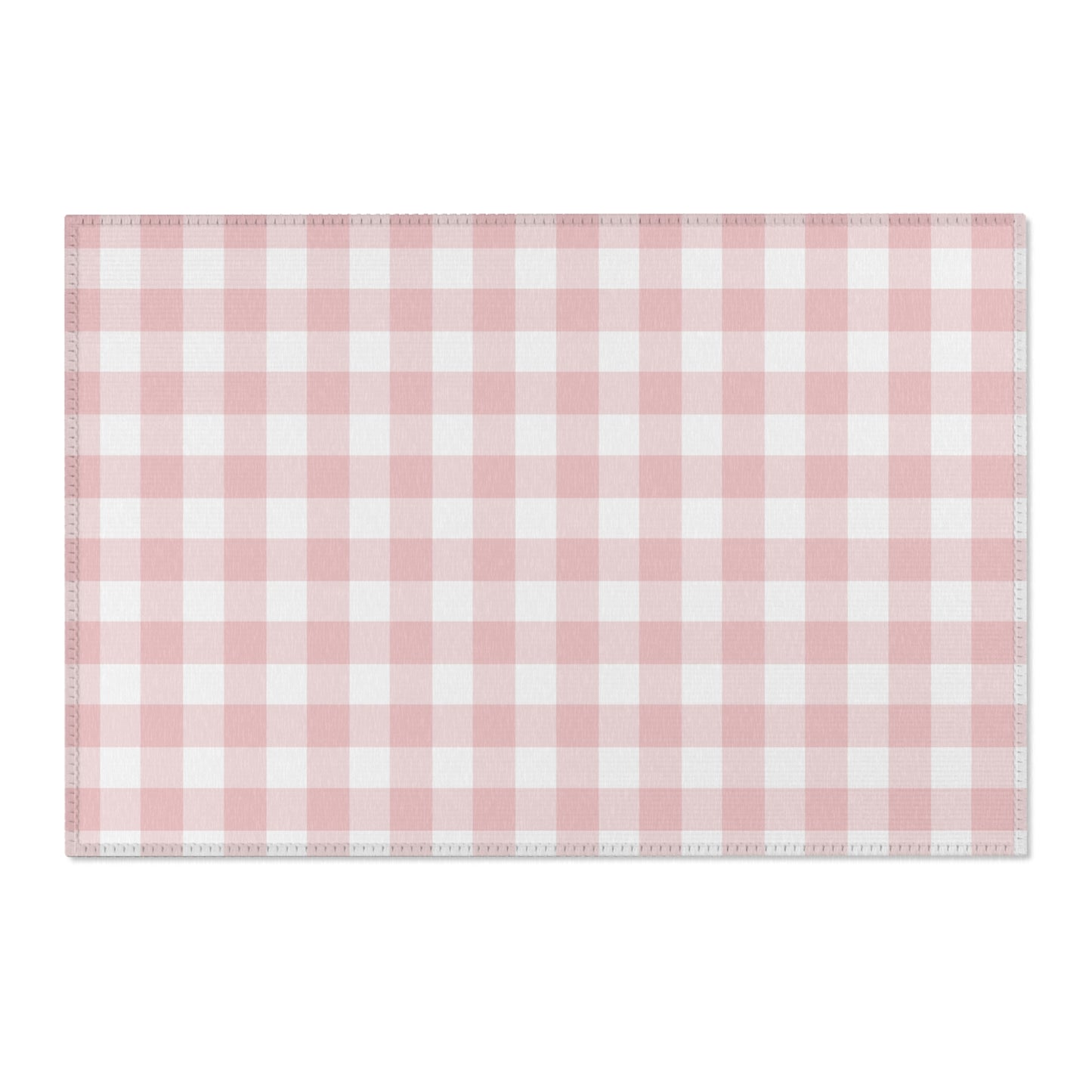 Pink gingham area rug beside a nursery crib