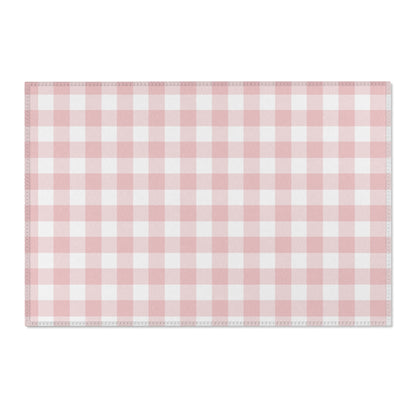 Pink gingham area rug beside a nursery crib