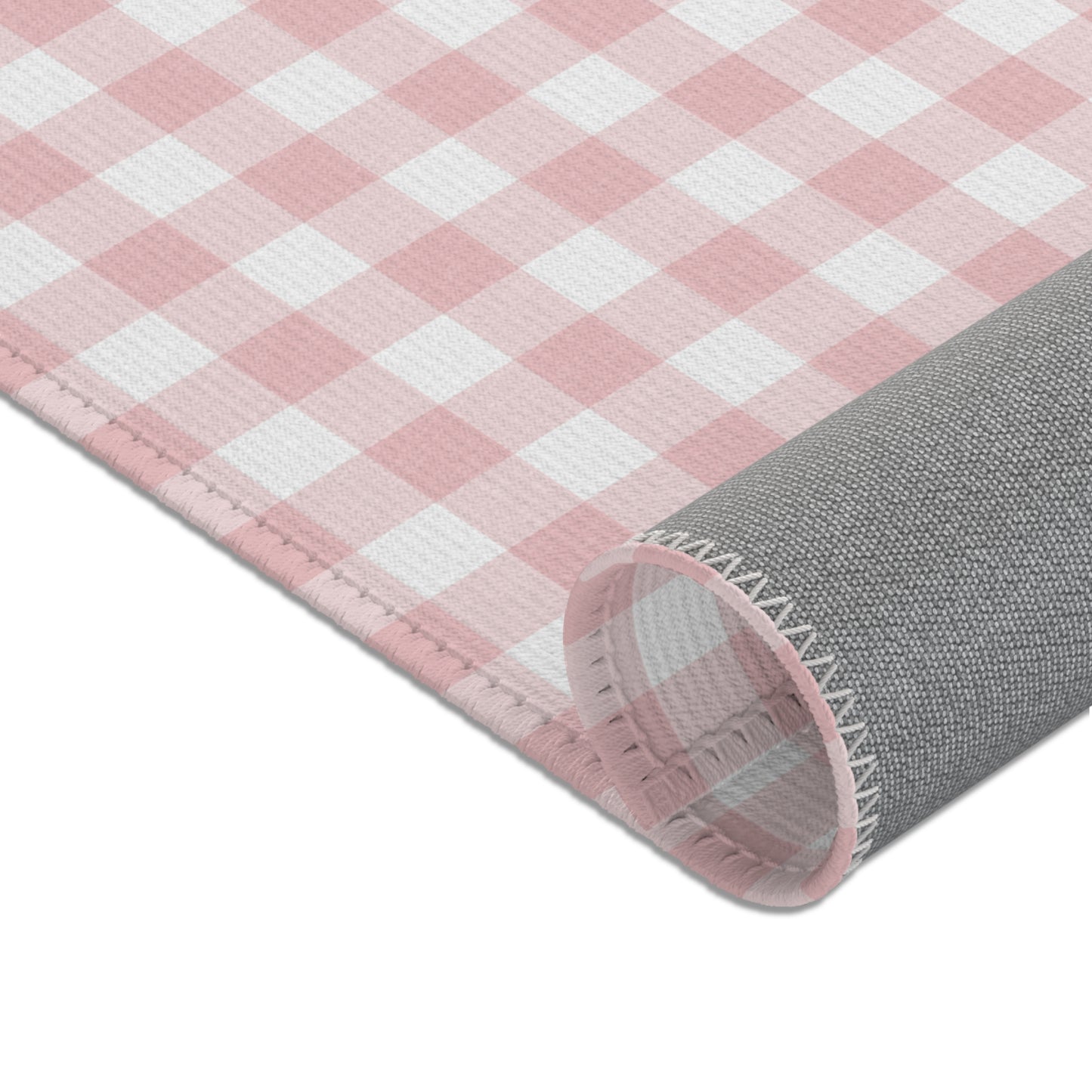 Vintage pink gingham nursery rug under a crib