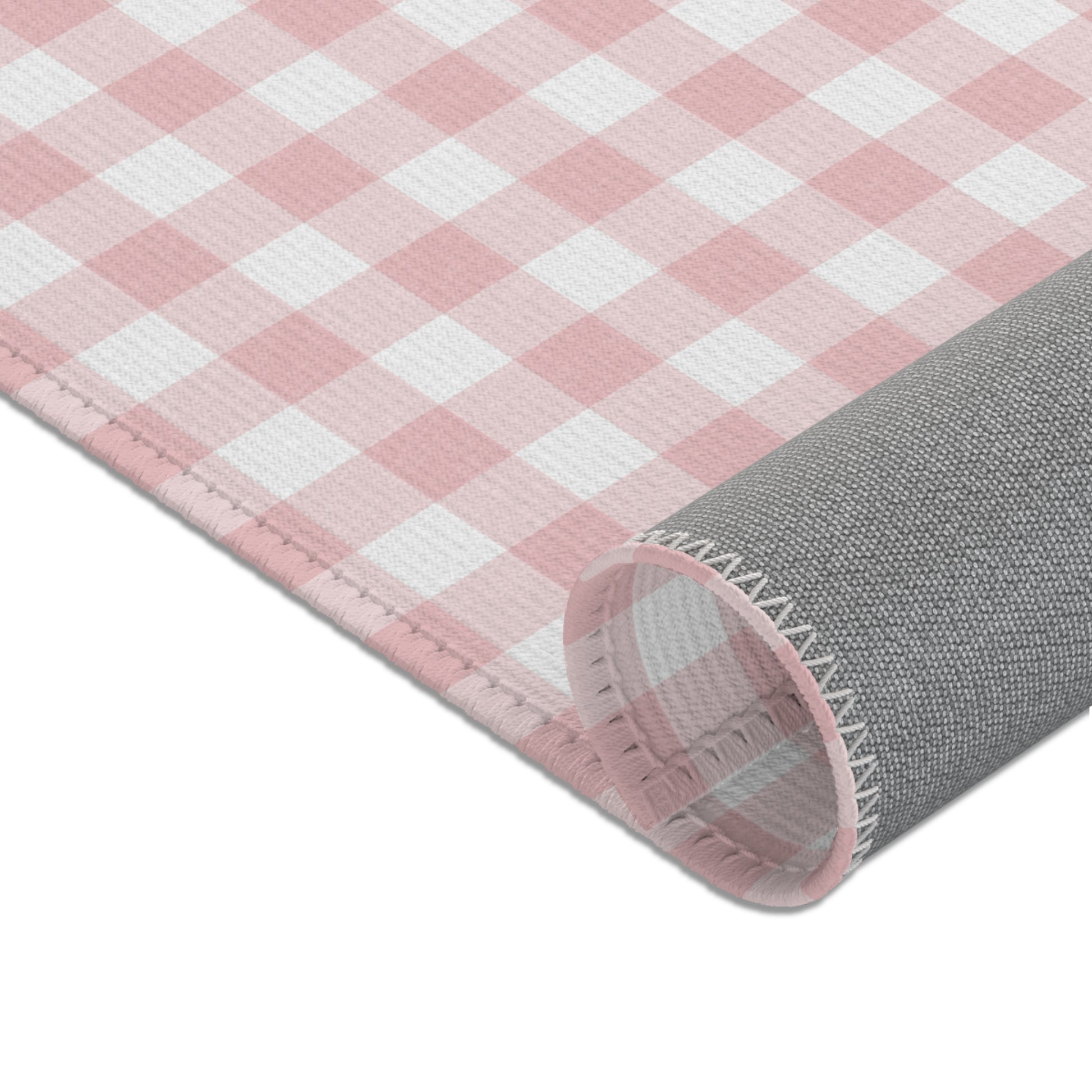 Vintage pink gingham nursery rug under a crib