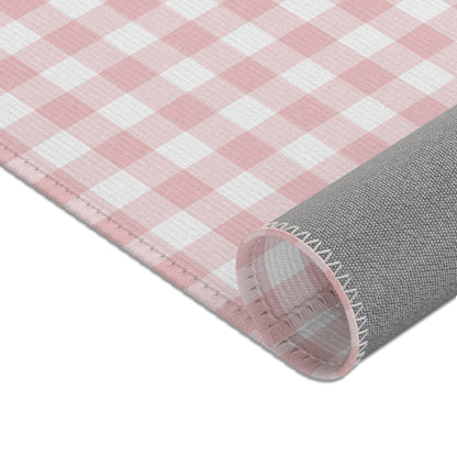 Vintage pink gingham nursery rug under a crib