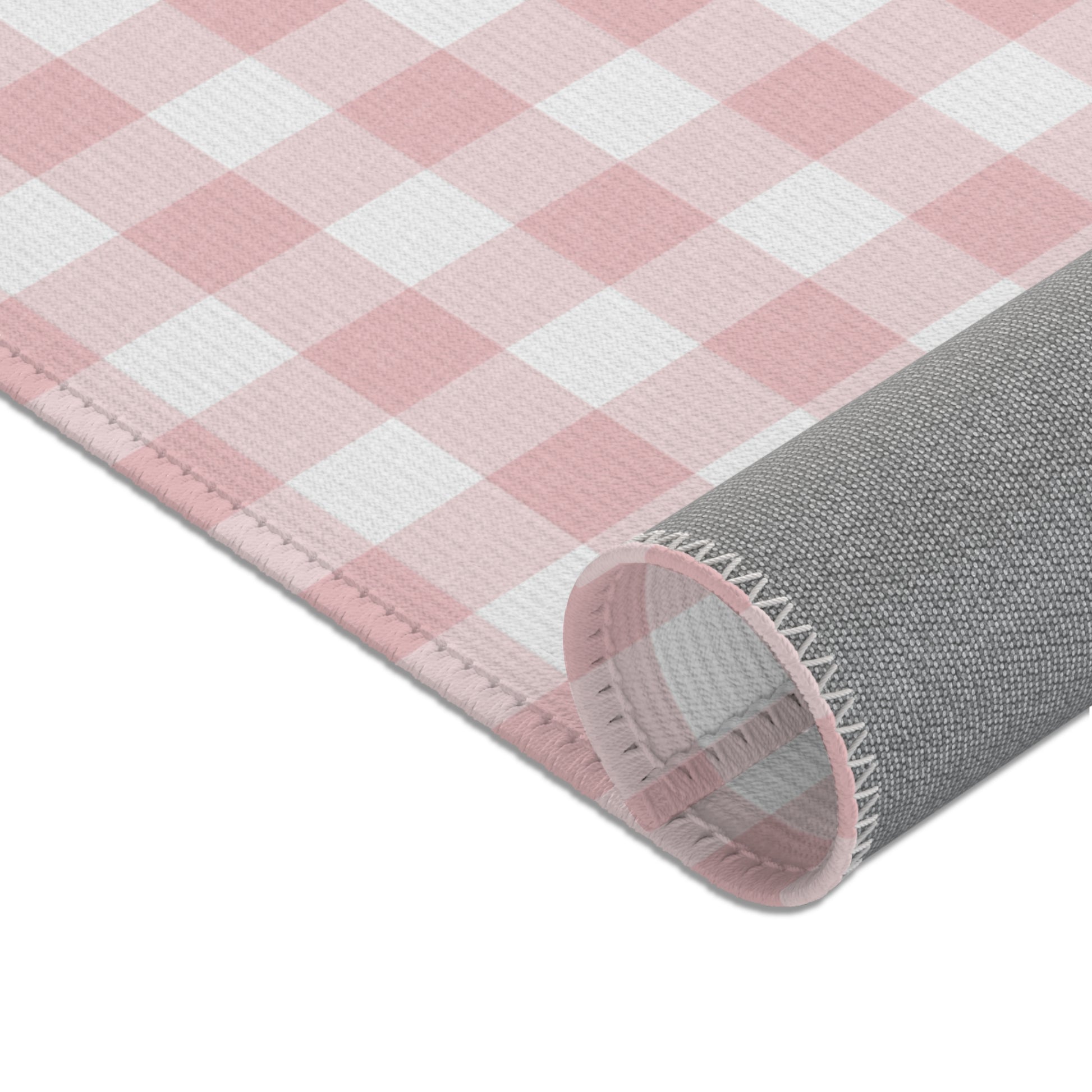 Dusty rose check rug beside a nursery glider chair