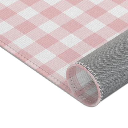Dusty rose check rug beside a nursery glider chair